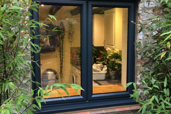 Black aluminium casement windows on a stone building