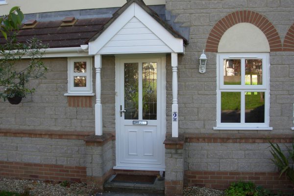 White uPVC residential door with glazing on a cream brick house