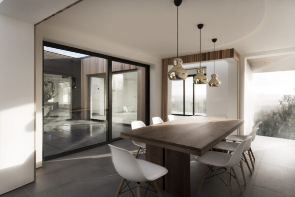 Aluminium patio sliding doors within a white dining room