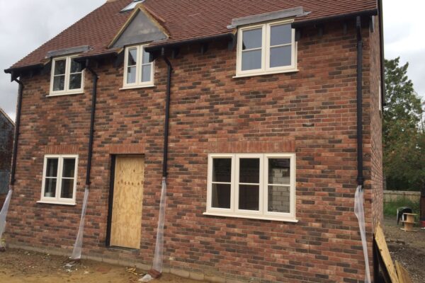 red brick house with uPVC 2500 windows